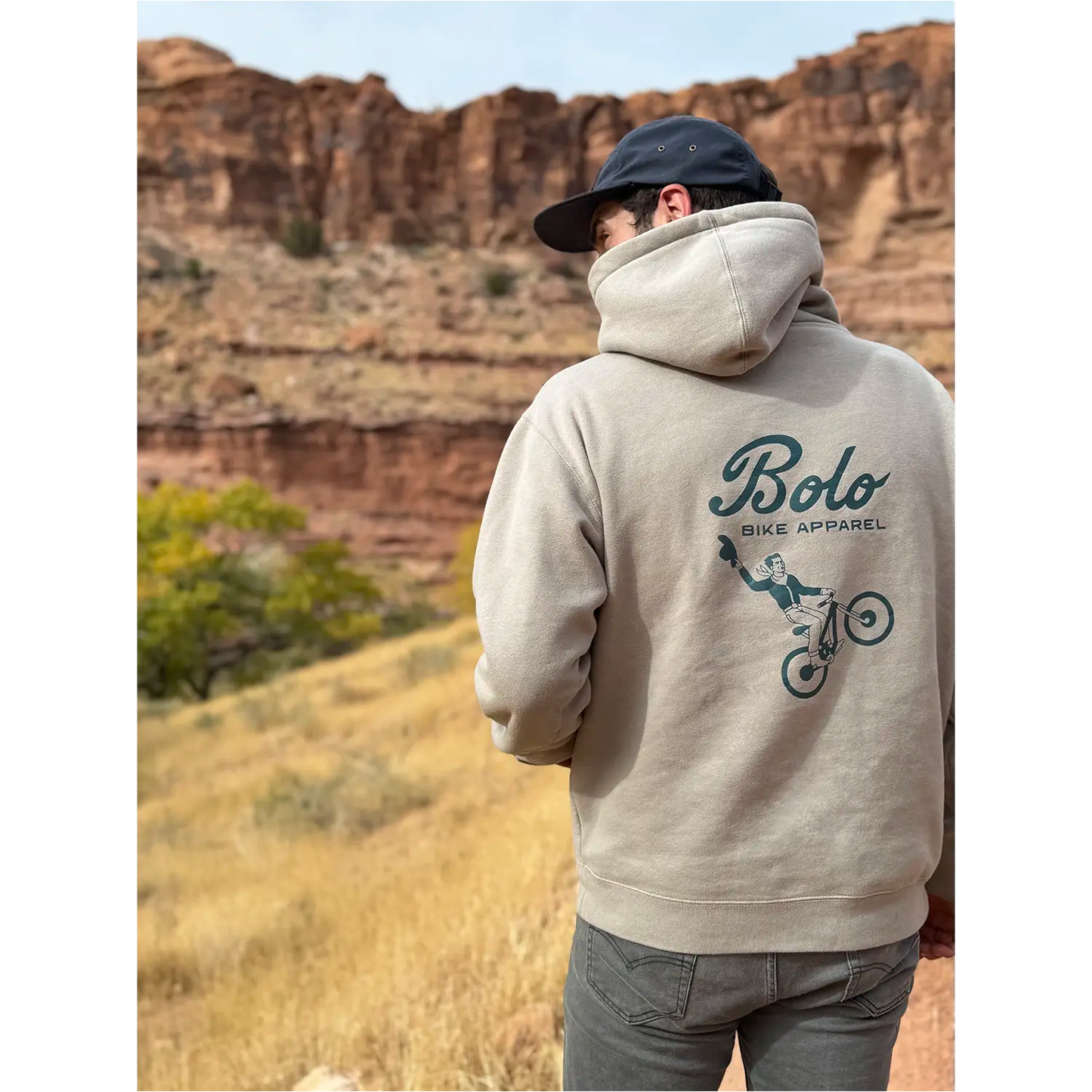 Model wearing Desert Drifter hoodie in a desert landscape