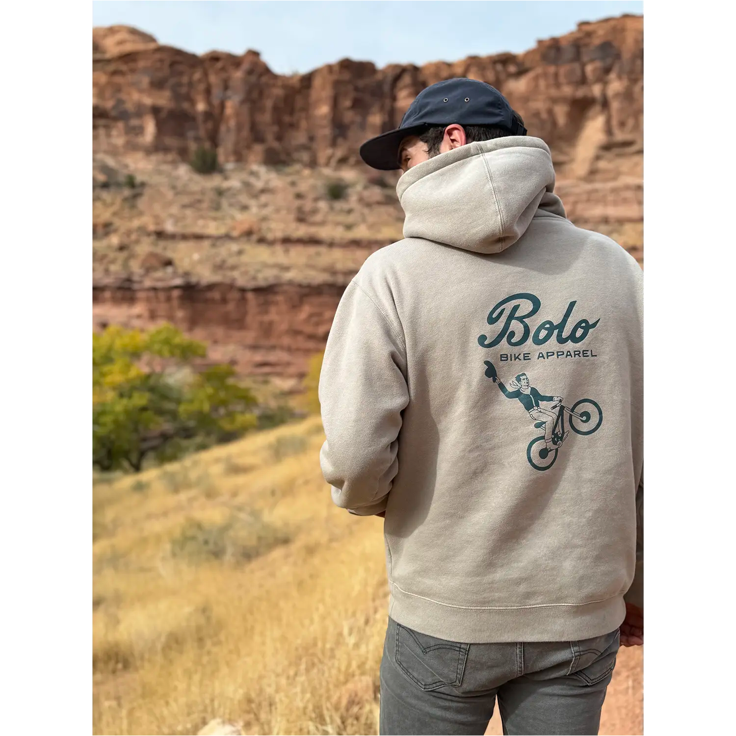 Model wearing Desert Drifter hoodie in a desert landscape